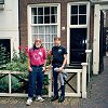 Bill and Larry in front of a home with a rose garden