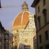 The sun is setting and casting a glow on the Duomo, - the main cathedral in Florence.