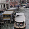 The public transit system is a fleet of small boats called Vaporetti that travel up - and down the main canals.  Here you see two of the Vaporetti on the Grand Canal.
