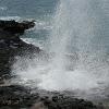The waves come in under the lava rock and the water - shoots up into the air through a hole in the lava.  