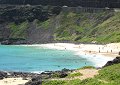 A view of Makapuu Beach.  We found that there is no path from the beach to the park where the - lighthouse is located, so we had to walk along the busy highway you see above the beach.