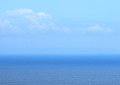 If you look closely, you can see the island of Molokai rising out of the - ocean on the horizon about 40 miles away.  Look right below the clouds.