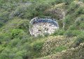 This looks like an old bunker built into the side of the crater. 