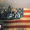 At the Harley Davidson Cafe: an American flag made from chains. - They said it was the world's heaviest flag. - The bikes were hanging from a moving chain.