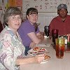 Pat, Tracy, George, and Larry at lunch in Wagon Mound - at a restaurant with local ranch brands on the walls.