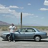 The car is half in Nevada and half in Utah. - Look over the front windshield and you can see that - signs, fences, and survey stakes don't agree on a precise point.