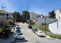 Larry on Hopkins Street. Sutro Tower is on the left and city communications towers - at Christmas Tree Point (the tourist vista point) are nearer to the center.