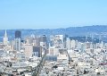 Downtown as seen from the south Twin Peak. - The Bay Bridge is on the right side of the picture and - the bell tower at the University of California in Berkeley - can be seen above the nearest bridge tower.