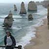 Bill at the visitor's overlook with some of the Twelve Apostles behind him. - We felt right at home with the fog blowing in off the ocean.