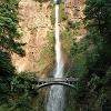 An arched bridge crosses in front of Multanomah Falls.