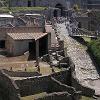 Pompeii was buried by lava and ash from Mt. Vesuvius in A.D. 79.  In 1594 workers - digging a tunnel to supply water to a nearby village found the first signs of the old city. - But it wasn't until 1748 that workers started digging at the site of Pompeii, - and that work continues to this day.  Shown here is entrance to the ruins.