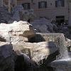 People sit around the fountain to rest and enjoy the cool breezes