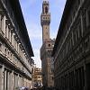 Standing in the courtyard of the Uffizi Gallery looking north with - the castle turret of the Palazzo Vecchio seen in the distance.