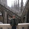 Larry on the rooftop with a line of spires behind him.