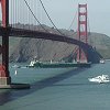 A ship passes under the bridge.