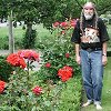 Bill by the beautiful roses in the front yard
