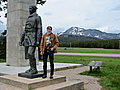 Larry stands next to the statue of John Stevens at the Roosevelt memorial