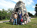 June 27 we just hung out at John and John's home. - June 28: John L., Bill and John S. at a roadside monument near - Kewadin, Michigan, that has a stone from each county in the state.